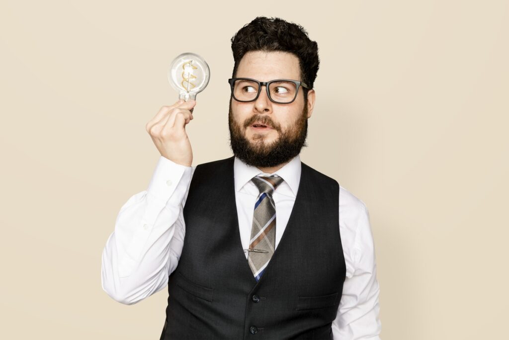 Bearded businessman mockup psd holding a light bulb for innovation campaign
